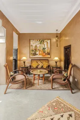 a living room with a couch and a table and chairs at Dar Beija in Marrakech