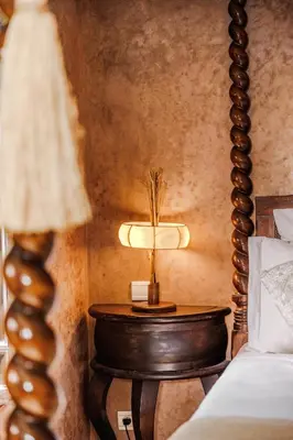 a table with a lamp on it next to a bed at Dar Beija in Marrakech