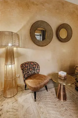 a living room with a chair and a table at Dar Beija in Marrakech