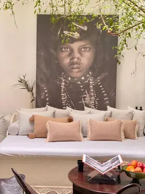 a painting of a black girl on a wall at Riad Wabisabi in Marrakech