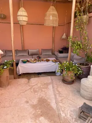 a living room with a couch and a table at Riad Wabisabi in Marrakech