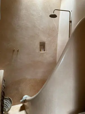 a bathroom with a staircase with a shower and a sink at Riad Wabisabi in Marrakech
