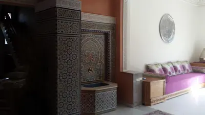 a large cabinet in a room with a purple couch at Villa clos Odette in Marrakech