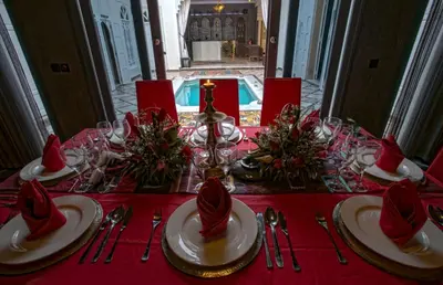 a table with a red table cloth with hats on it at RIAD DREAMS in Marrakech