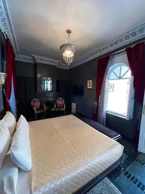 a bedroom with a large bed and a window at RIAD DREAMS in Marrakech
