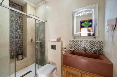 a bathroom with a sink and a shower and a toilet at Emma's Riad in Marrakech