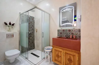 a bathroom with a shower and a toilet and a sink at Emma's Riad in Marrakech