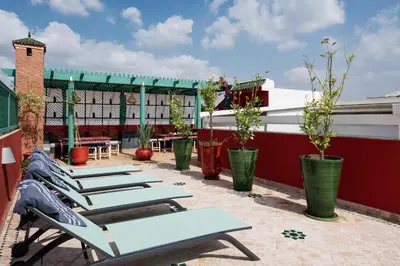 a row of lounge chairs on a rooftop patio at Emma's Riad in Marrakech