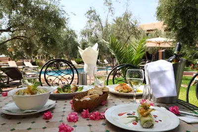 a table with plates of food and wine on it at Boutique Hotel Katia in El Harkat
