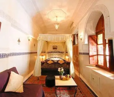 a bedroom with a bed in a room at Dar Al Kounouz in Marrakech
