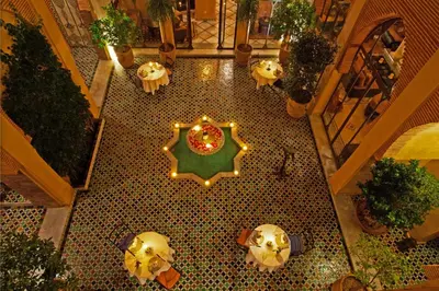 an overhead view of a restaurant with a table and lights at Riad Le Perroquet Bleu Suites & Spa in Marrakech