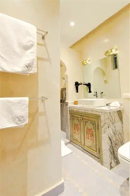 a bathroom with a sink and a toilet at Riad Tahyra in Marrakech