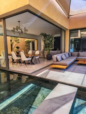 a living room with a pool in the middle of a house at Villa Oxygène Marrakech in Marrakech