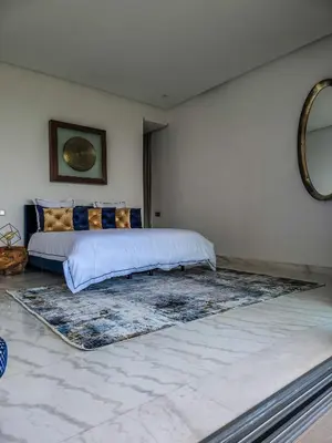 a bedroom with a bed and a large rug at Villa Oxygène Marrakech in Marrakech