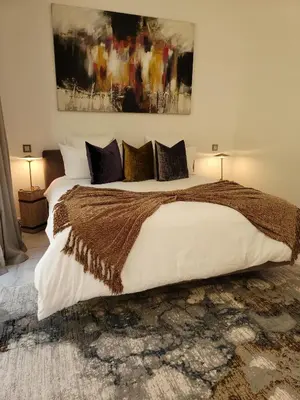 a bedroom with a large bed with white sheets and pillows at Villa Oxygène Marrakech in Marrakech