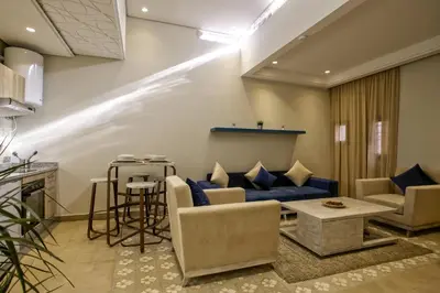 a living room with a blue couch and a table at BnB MEDINA in Marrakech