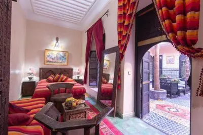 a living room with a couch and a table at Riad Lalla Khiti in Marrakech