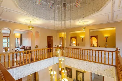 a large room with a staircase with a ceiling at Domaine Rosaroum in Marrakech