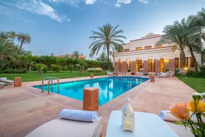 a villa with a swimming pool and a resort at Domaine Rosaroum in Marrakech