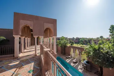 a balcony of a building with a fence and trees at Residence Dar Lamia Marrakech in Dar Caïd Layadi