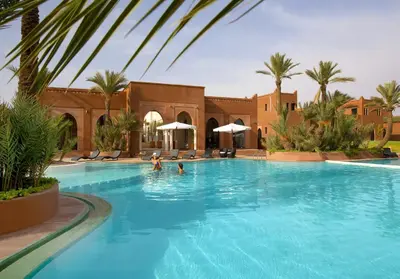 a swimming pool with people in the water at Residence Dar Lamia Marrakech in Dar Caïd Layadi