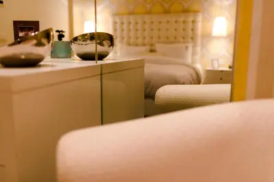 a hotel room with two beds and a mirror at Residence Dar Lamia Marrakech in Dar Caïd Layadi