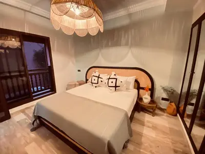 a bedroom with a bed with two pillows on it at Cosy stays central apartements , guéliz Marrakech in Marrakech