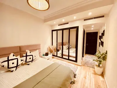 a bedroom with a large bed and a large window at Cosy stays central apartements , guéliz Marrakech in Marrakech