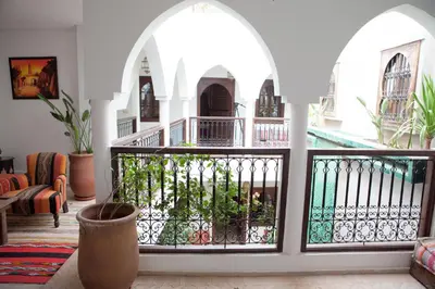 a living room with a balcony with a fence at Riad Achwaq in Marrakech