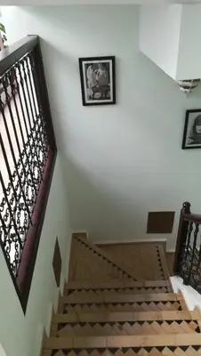 a stairway with a wooden railing and a stair case at Riad Achwaq in Marrakech