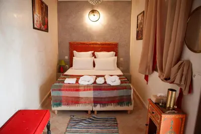 a bedroom with a bed with towels on it at Riad Achwaq in Marrakech
