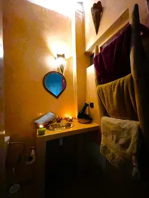 a bathroom with a sink and a mirror on the wall at Riad dar Assou in Marrakech