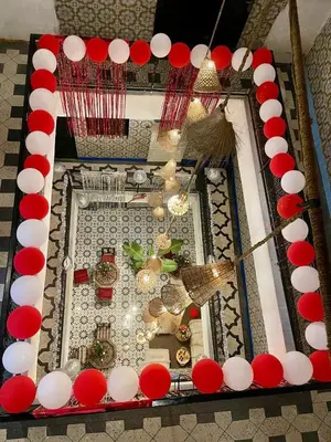 a mirror with red and white decorations on a table at Riad dar Assou in Marrakech