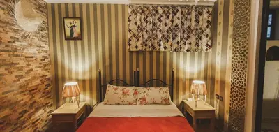 a bedroom with a bed with two lamps on tables at Be Nomad in Marrakech