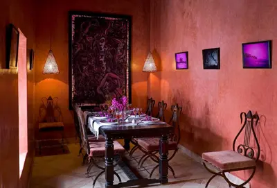 a dining room with a table with flowers on it at Riad Meriem in Marrakech