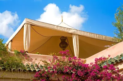 a gazebo with pink flowers on a building at Riad Meriem in Marrakech