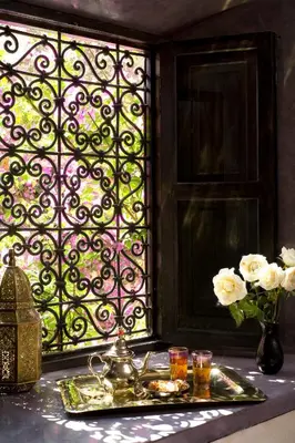 a tray of food on a table next to a window at Riad Meriem in Marrakech