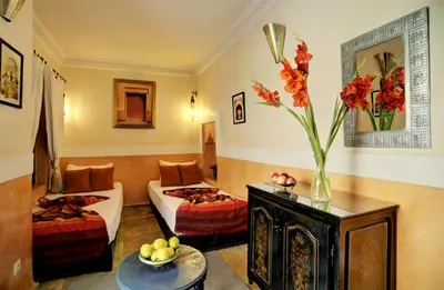 a living room with a couch and a table at Riad Dar El Souk in Marrakech