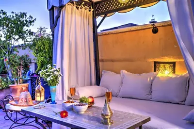 a table with food on a couch on a patio at Riad Dar El Souk in Marrakech