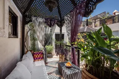 a pergola with a couch on a patio at Riad Dar El Souk in Marrakech