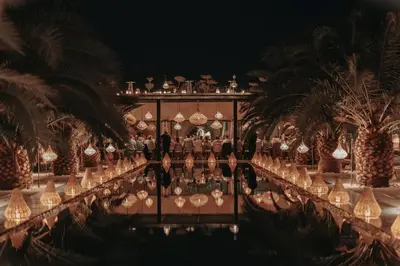 a group of people standing in a room with palm trees at Villa Taj Marrakech in Marrakech
