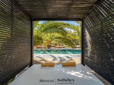 a room with a view of a swimming pool through a window at Villa Taj Marrakech in Marrakech