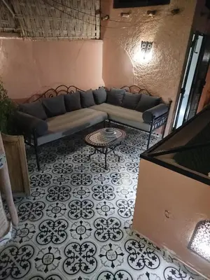 a living room with a couch and a table at Riad Bab Lakhmiss in Marrakech