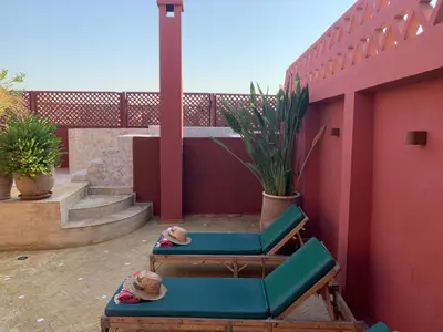 a patio with two lounge chairs and a fence at Riad Le Limoun and Spa in Marrakech