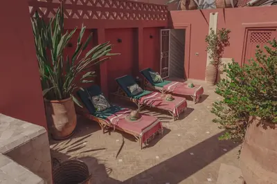 a group of chairs and ottomans on a patio at Riad Le Limoun and Spa in Marrakech