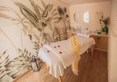 a hospital room with a bed in a room with plants at Riad Le Limoun and Spa in Marrakech