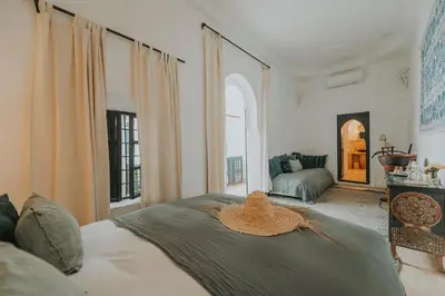a bedroom with a bed with a straw hat on it at Dar El Qadi in Marrakech