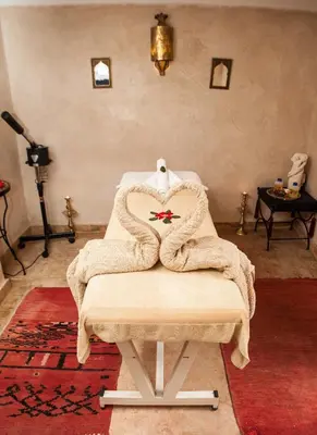 a blanket sitting on a table in a room at Riad dar Ourika & SPA in Marrakech