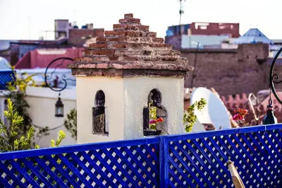 a small building on a blue fence at Riad dar Ourika & SPA in Marrakech
