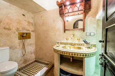 a bathroom with a sink and a toilet at Riad dar Ourika & SPA in Marrakech